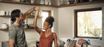 Couple dancing to Flaev music in kitchen
